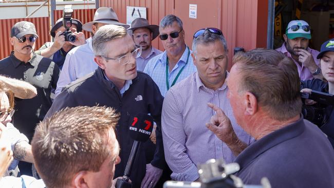 Eugowra resident Peter Jones, right, speaks to NSW Premier Dominic Perrottet on Friday. Picture: Getty Images