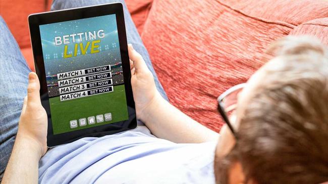 Man betting online on a tablet. Picture: milindri