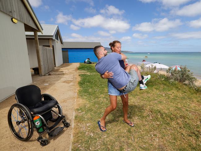 Vivian carries her son Ben down to the beach. Picture: Ian Currie