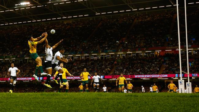 CARDIFF, WALES - SEPTEMBER 23: Israel Folau of Australia jumps for the ball with Metuisela Talebula and Asaeli Tikoirotuma of Fiji during the 2015 Rugby World Cup Pool A match between Australia and Fiji at the Millennium Stadium on September 23, 2015 in Cardiff, United Kingdom. (Photo by Dan Mullan/Getty Images)