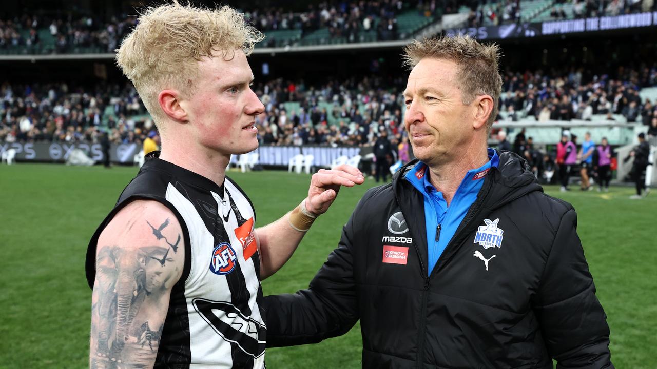 John and David Noble embrace after Collingwood’s Round 17 game against North Melbourne.