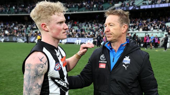 John and David Noble embrace after Collingwood’s Round 17 game against North Melbourne.