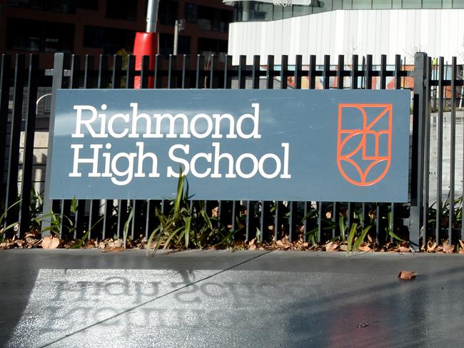 MELBOURNE, AUSTRALIA - NewsWire Photos AUGUST 5: A lone dog walker passes an empty Richmond High School in Melbourne. Picture: NCA NewsWire / Andrew Henshaw