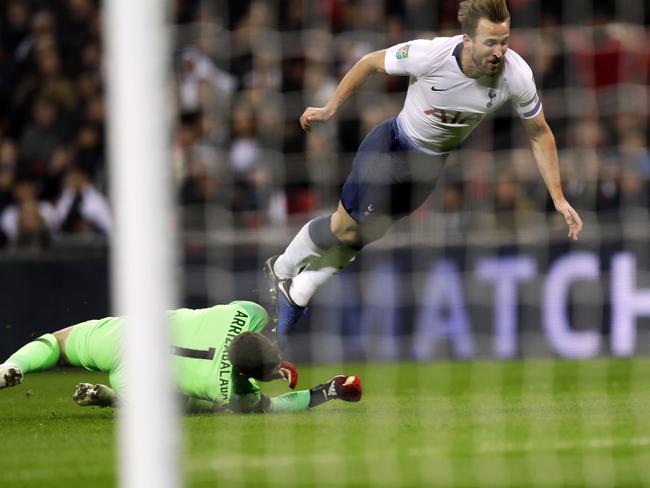 Tottenham's Harry Kane, falls as he challenges, Chelsea's goalkeeper Kepa Arrizabalaga during the English League Cup semifinal first leg soccer match between Tottenham Hotspur and Chelsea at Wembley Stadium in London, Tuesday, Jan. 8, 2019. (AP Photo/Kirsty Wigglesworth)