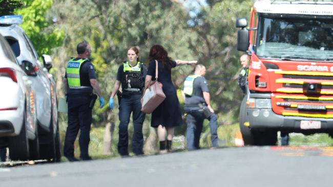 A woman talks to police near the scene. Picture: David Caird