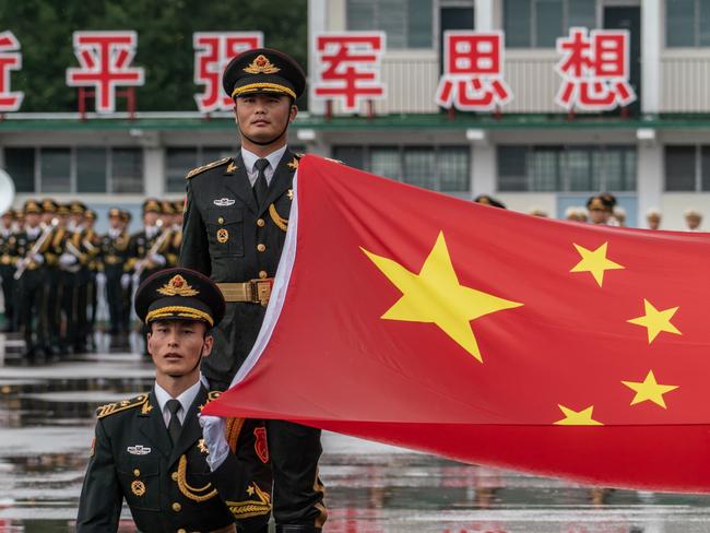 HONG KONG, HONG KONG - June 30: Members of the People's Liberation Army (PLA) attend a flag raising ceremony at the Shek Kong Barracks on June 30, 2018 in Hong Kong, Hong Kong. Hong Kong will mark 21 years since its return to Chinese sovereignty from British rule on Sunday as thousands of people are expected to turn up for an annual rally to demand full democracy and vent their frustration over the soaring accommodation costs in the world's most expensive city for expatriates. (Photo by Anthony Kwan/Getty Images)