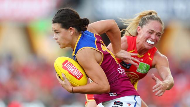 GOLD COAST, AUSTRALIA - FEBRUARY 22: Sophie Conway of the Lions is tackled by Leah Kaslar of the Lions during the round three AFLW match between the Gold Coast Suns and the Brisbane Lions at Metricon Stadium on February 22, 2020 in Gold Coast, Australia. (Photo by Chris Hyde/Getty Images)