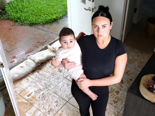 Brittany Opetaia-Halls and daughter Milana-Mae Opetaia-Halls 6months, had her house flooded yesterday because of council work in front of her place, Kallangur - on Wednesday 18th December 2024 - Photo Steve Pohlner