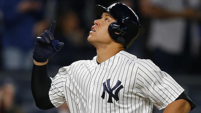 Aaron Judge #99 of the New York Yankees gestures after he hit a two-run home run in the third inning against the Toronto Blue Jays during a game at Yankee Stadium.
