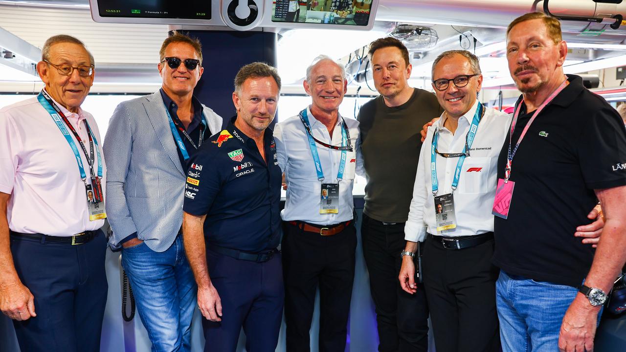 Elon Musk, Larry Ellison and notable figures pose for a photo in the Red Bull Racing garage during final practice ahead of the F1 Grand Prix of Miami. Picture: Getty