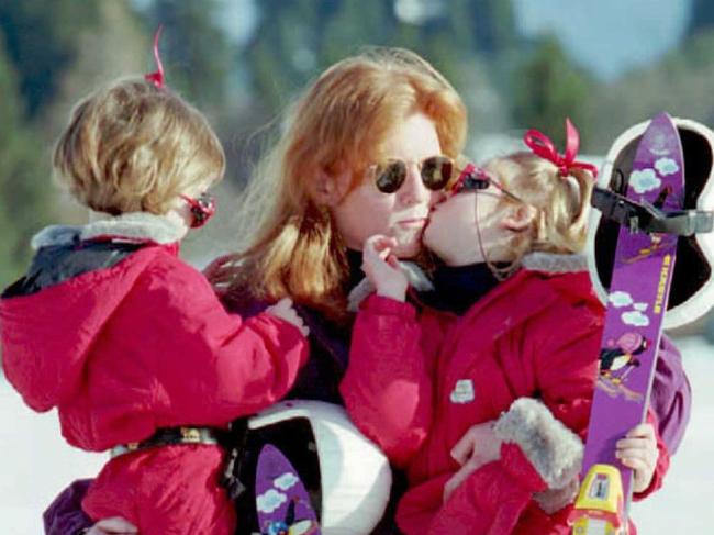 Princess Eugenie gives her mum a peck as sister Princess Beatrice looks on during an annual ski trip at Klosters, Switzerland.