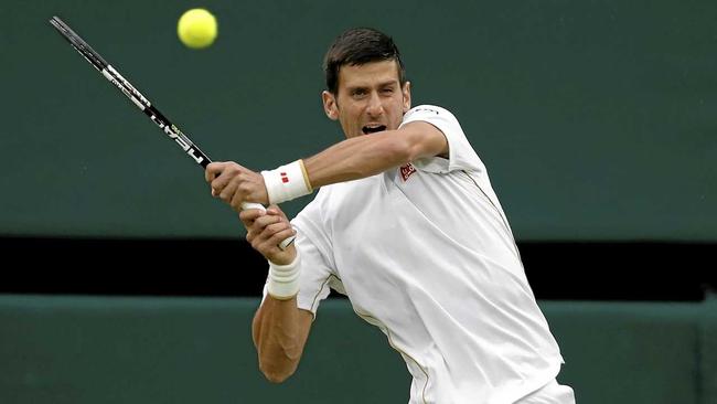 STREAK CONTINUES: Novak Djokovic of Serbia returns to Frenchman Adrian Mannarino in the second round at Wimbledon. Picture: Ben Curtis