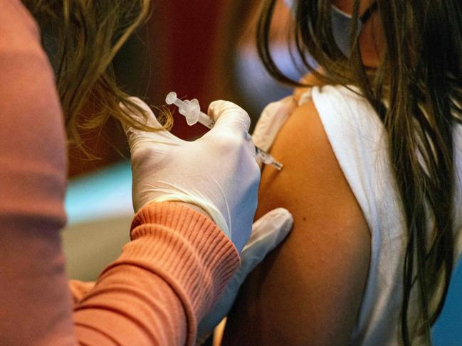 A five year old child receives the Pfizer-BioNTech Covid-19 Vaccine for 5-11 year old kids at Hartford Hospital in Hartford, Connecticut on November 2, 2021. - An expert panel unanimously recommended Pfizer-BioNTech's Covid vaccine for five- to 11-year-olds on November 2, the penultimate step in the process that will allow injections in young children to begin this week in the United States. The Centers for Disease Control and Prevention (CDC), the top US public health agency, was expected to endorse that recommendation later in the day. (Photo by JOSEPH PREZIOSO / AFP)