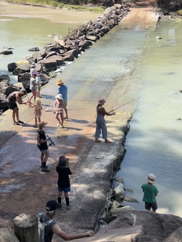 A number of people gathered on and even in the water at the dangerous spot.