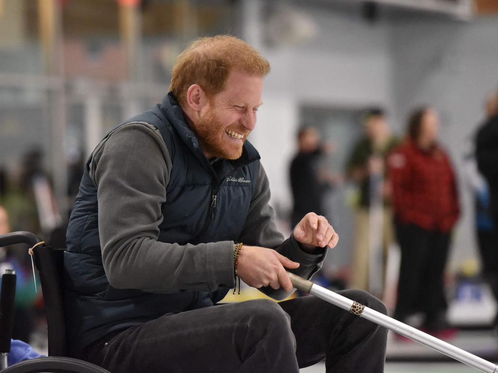 Prince Harry laughs as he takes part in the demonstration. Picture: AFP