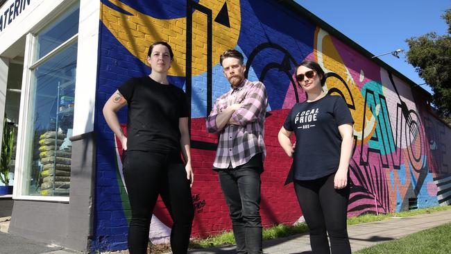 Cafe owner Jessie Crossley, and artists Paul and Georgie Sonsie are campaigning to keep the mural. Picture: Stuart Milligan