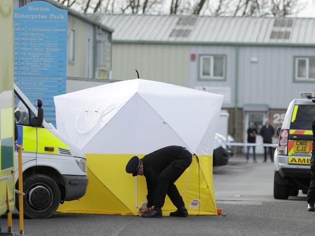 Police erect a screen outside a vehicle recovery business in Salisbury after the attack. Picture: Matt Dunham.