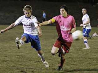 Woombye clears the ball under pressure. Picture: Cade Mooney