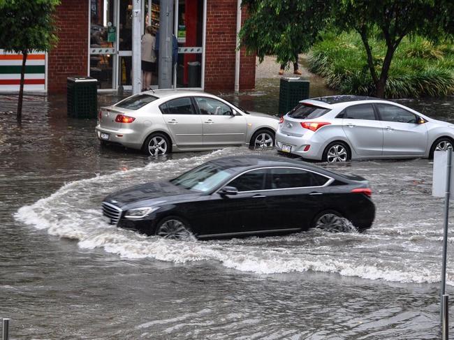 A driver braves floodwater on Commercial Rd, in Melbourne's south. Picture: Alexandra Owen