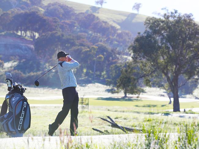 Greg Norman tees off at Cathedral Lodge. Picture: David Crosling