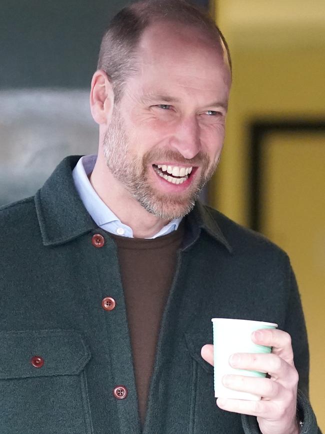 William grins while downing a hot chocolate. Picture: Dominic Lipinski – WPA Pool/Getty Images