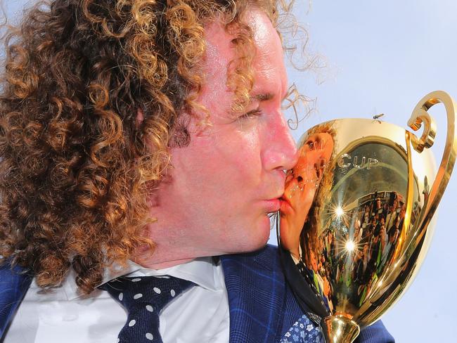 Trainer Ciaron Maher kisses the Caulfield Cup.