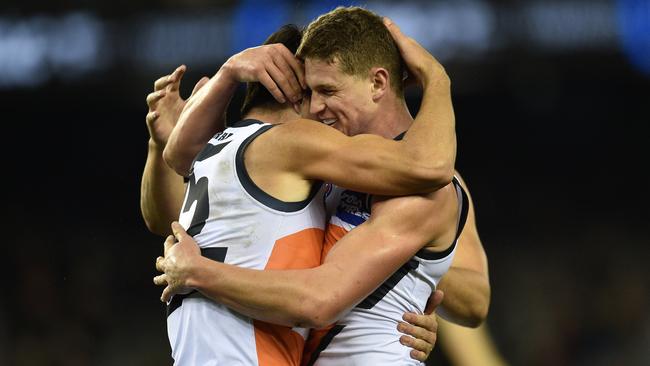 Matthew Kennedy (left) and Jacob Hopper of the Giants react after Kennedy kicked a goal during the Round 13 AFL match between the Essendon Bombers and the GWS Giants at Etihad Stadium in Melbourne, Sunday, June 19, 2016. (AAP Image/Julian Smith) NO ARCHIVING, EDITORIAL USE ONLY
