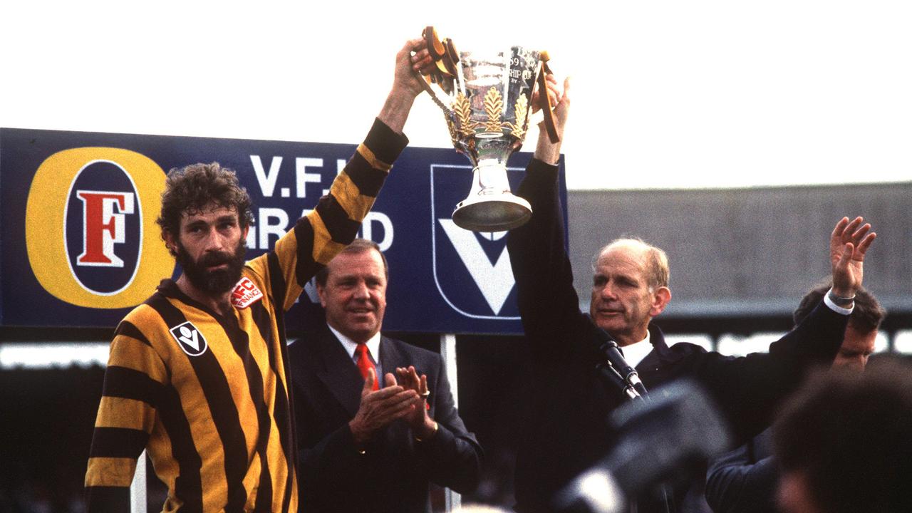 Hawthorn captain Michael Tuck and coach Allan Jeans hold up the 1989 premiership cup after defeating Geelong.