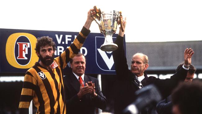 Hawthorn captain Michael Tuck and coach Allan Jeans hold up the 1989 premiership cup after defeating Geelong.