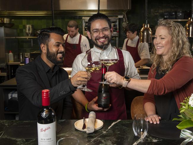 JUNE 10, 2022: Eleven is hosting a $300 a head dinner with Penfolds later this month. Staff member Clayton Johnson serving Divesh Lormorh and Nikki Potter. Picture: Naomi Jellicoe