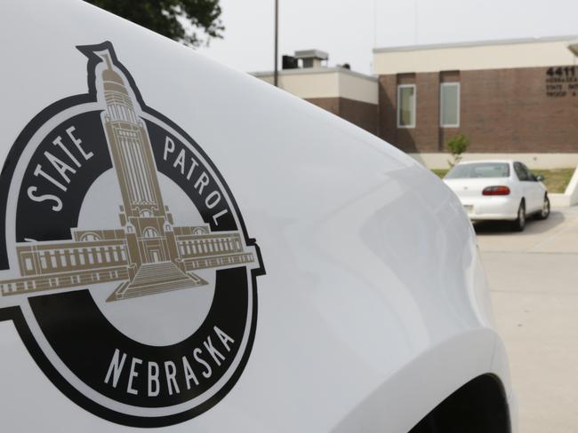 A vehicle with the Nebraska State Patrol logo is parked in a state patrol facility in Omaha, Neb., Wednesday, Aug. 2, 2017. A federal lawsuit accuses the Nebraska State Patrol that it has for years forced female recruits to submit to invasive, medically unnecessary pelvic exams performed by a male doctor before they can be hired. (AP Photo/Nati Harnik)