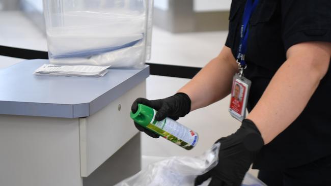 HOBART, AUSTRALIA - MARCH 19: Biosecurity officers disinfecting paperwork supplied by passengers at Hobart airport on March 19, 2020 in Hobart, Australia. The Tasmanian premier Peter Gutwein has announced all interstate travellers will be required to quarantine for 14 days. The measures are the toughest to be imposed in Australia, and will come into effect from Friday 20 March. There are now 596 confirmed cases of COVID-19 In Australia, while there have been six confirmed deaths, five in NSW and one in Western Australia. (Photo by Steve Bell/Getty Images)