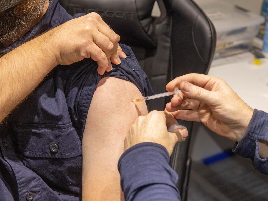 MELBOURNE, AUSTRALIA - JULY 11: A pharmacist administers the injection of a Covid-19 vaccination booster-shot to a customer at Exhibition Pharmacy on July 11, 2022 in Melbourne, Australia. More Australians are now eligible to receive a fourth dose of a COVID-19 vaccine, after the Australian Technical Advisory Group on Immunisation (ATAGI) approved people aged 30 and above can access additional booster shots from Monday 11 July. While over 30s are now eligible for an additional dose if they choose, health authorities are strongly urging people over 50 to get the fourth COVID-19 vaccine booster and for people to wear masks indoors in public as coronavirus infections continue driven by Omicron subvariants. (Photo by Asanka Ratnayake/Getty Images)