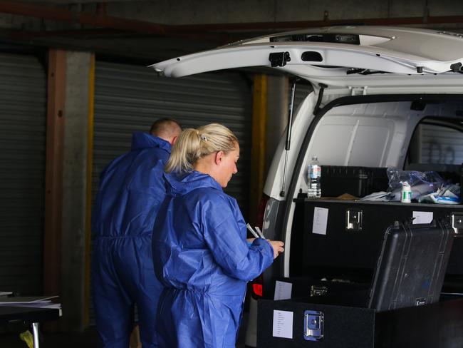 Forensics officers at the Levitt St unit block in Wyong where the body of Sean Froggatt was discovered. Picture: Gaye Gerard