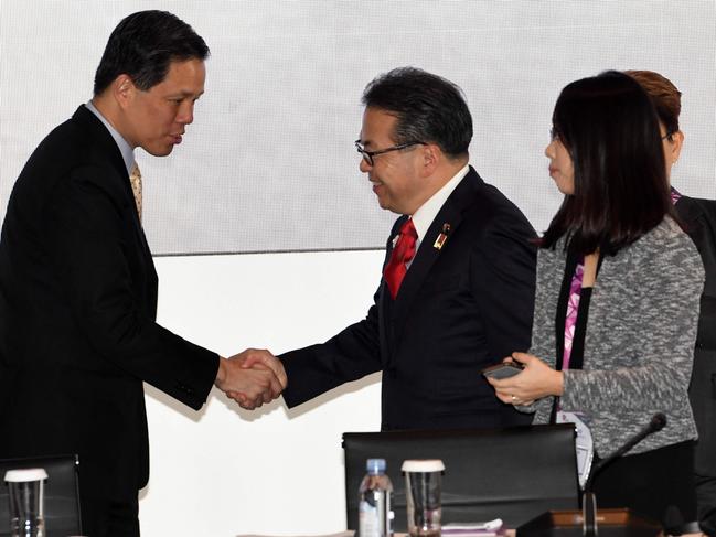 Japan's Minister of Economy, Trade and Industry Hiroshige Seko (R) shakes hands with Singapore Minister of Trade & Industry, Chan Chun Sing (L) during the 24th ASEAN Economic Ministers (AEM)- Ministry of Economy, Trade and Industry, Japan Consultations meeting in Singapore on August 30, 2018. (Photo by ROSLAN RAHMAN / AFP)