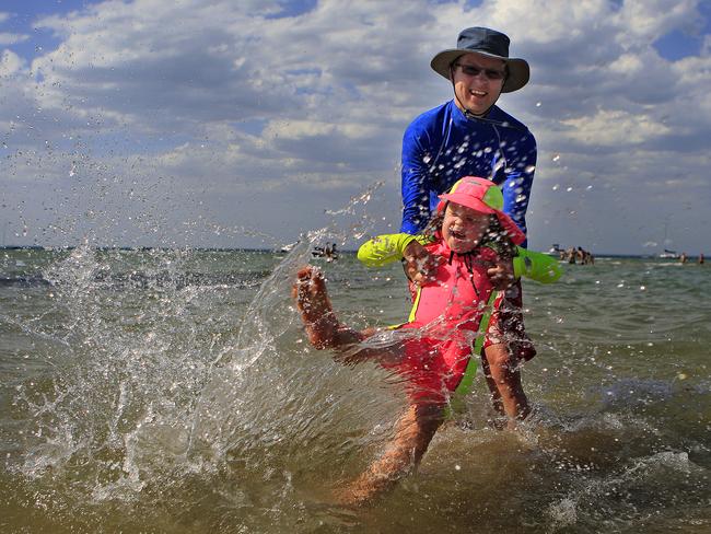 Matt from Malvern East spent New Year’s Eve 2010 splashing about at Rye beach with his daughter Lucy, 6. Picture: Chris Scott