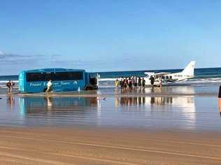 The Central Queensland Plane Spotting Blog has shared photos of a bus attempting to rescue the Air Fraser Island Airvan ahead of high tide. Picture: CQ Plane Spotting Blog