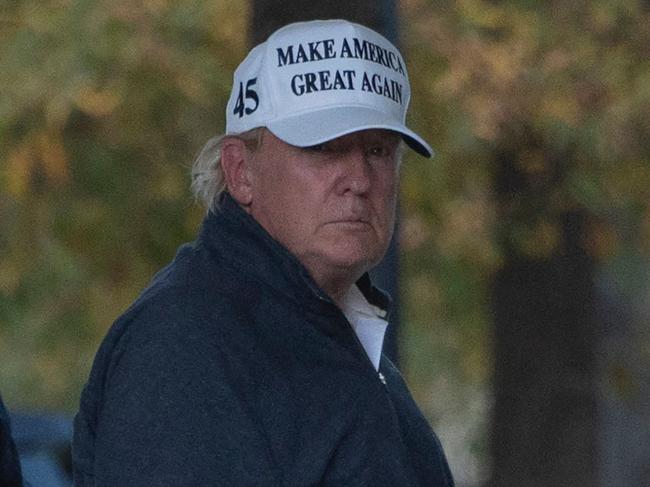 TOPSHOT - President Donald Trump returns to the White House from playing golf in Washington, DC on November 7, 2020, after Joe Biden was declared the winner of the 2020 presidential election. - Joyous celebrations erupted in Washington on Saturday after Joe Biden was declared winner of the US presidency, as several people poured into the streets of the US capital -- some of them chanting, cheering and singing in front of the White House. (Photo by ANDREW CABALLERO-REYNOLDS / AFP)