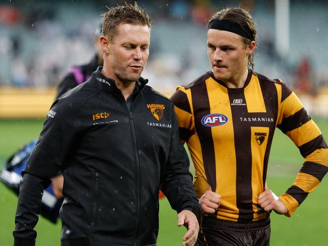 MELBOURNE, AUSTRALIA - APRIL 01: Sam Mitchell, Senior Coach of the Hawks and Jack Ginnivan of the Hawks are seen after a loss during the 2024 AFL Round 03 match between the Hawthorn Hawks and the Geelong Cats at the Melbourne Cricket Ground on April 01, 2024 in Melbourne, Australia. (Photo by Dylan Burns/AFL Photos via Getty Images)