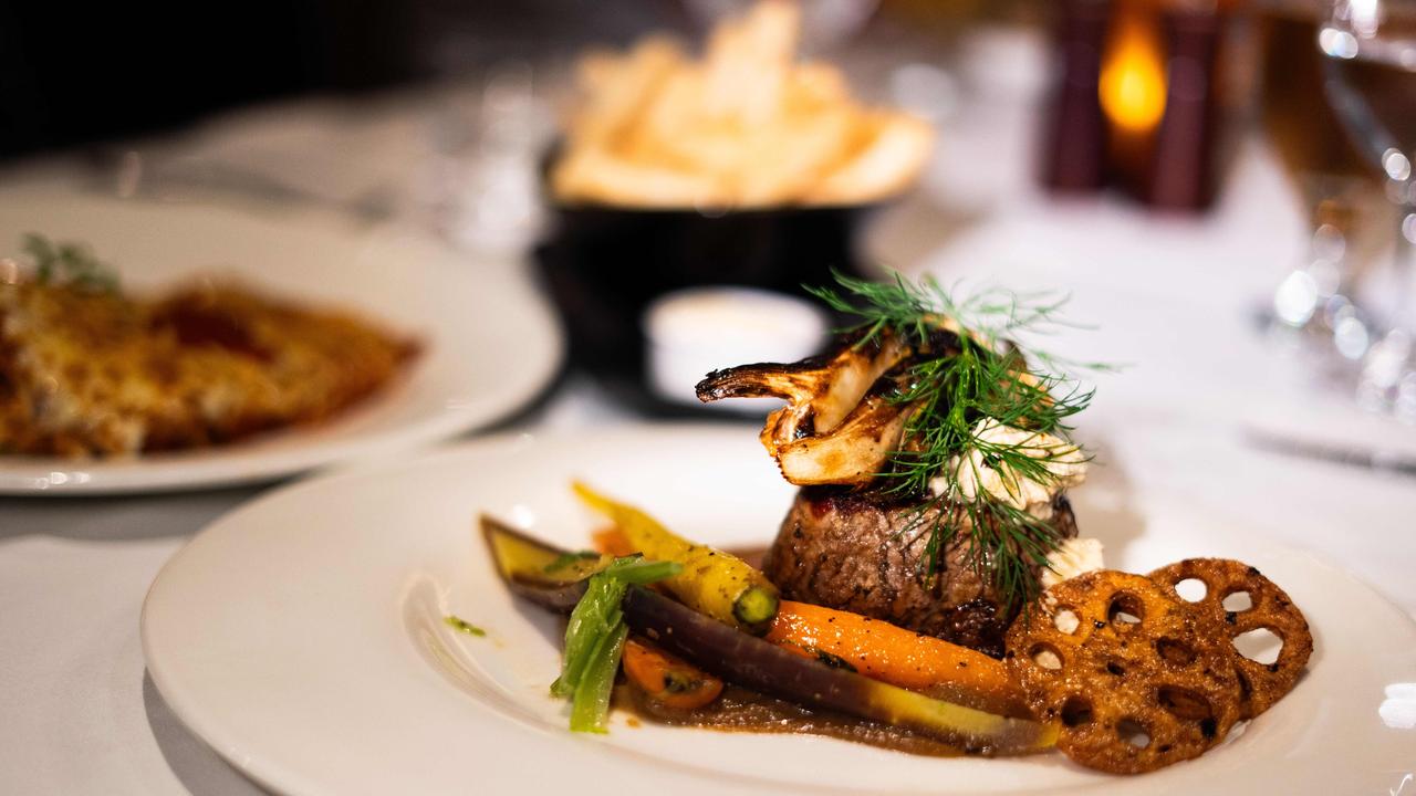 Black Angus beef tenderloin (foreground) and veal parmigiana (left) at Biviano’s. Picture: Tom Parrish