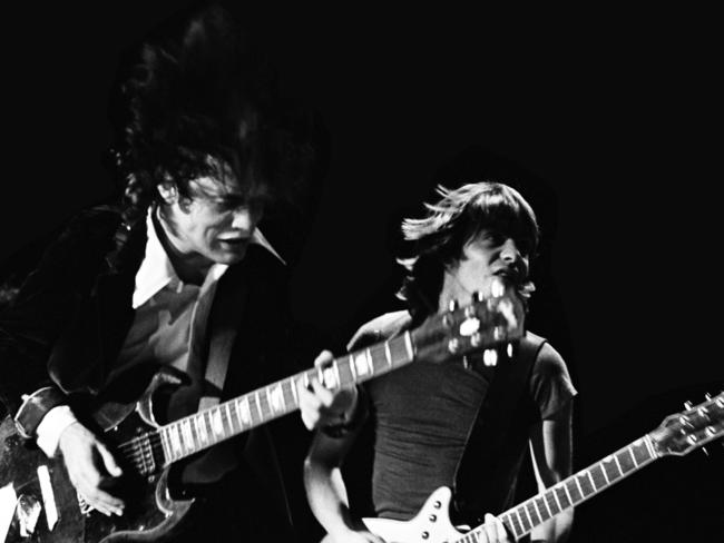 Brothers ... Angus and Malcolm Young on stage at Royal Oak Theater, Michigan, in 1978. Picture: Supplied