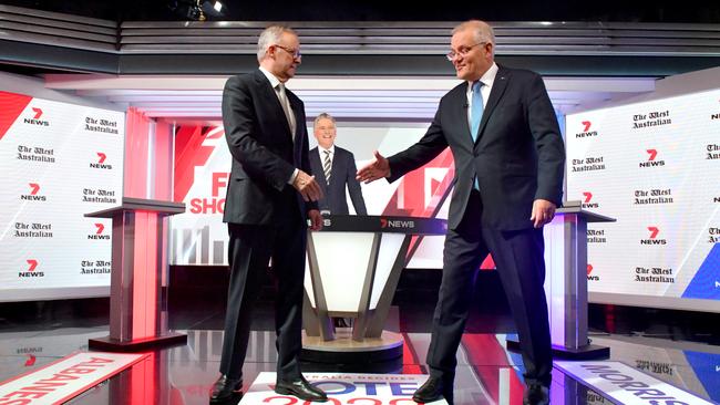 Scott Morrison and Anthony Albanese shake hands during the third leaders' debate at Seven Network Studios on Day 31 of the 2022 federal election campaign, in Sydney, Wednesday, May 11, 2022. (AAP Image/Mick Tsikas)