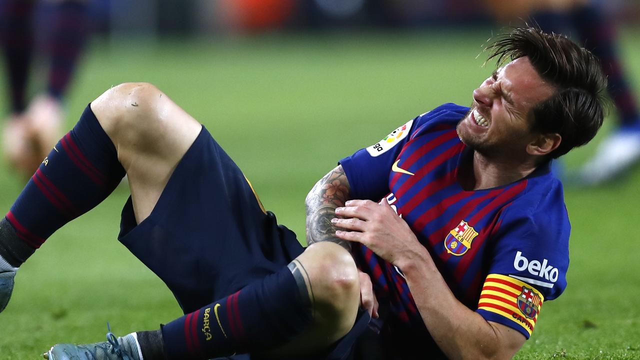 FC Barcelona's Lionel Messi in pain after breaking his arm