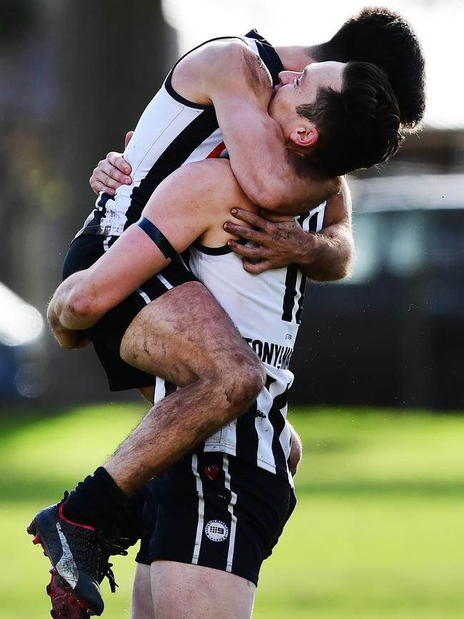 Alex Forster hugs Falcons teammate hugs Anthony Giannini during the match at Payneham Oval. Picture: AAP/Mark Brake