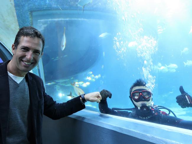 John Huang got the chance to swim with sharks as part of his prize to work with execs at The Adecco Group, including chief executive Rafael Moyano, left. Picture: Supplied