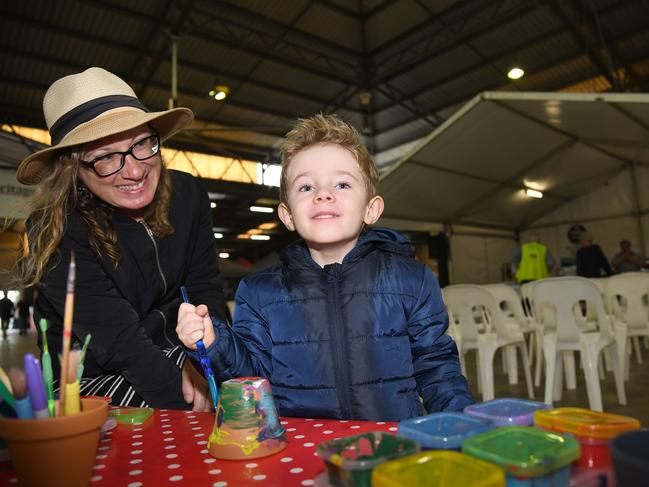 Therese Duranti and Luca Richardson painting pots in the Founders Pavillion. Heritage Bank Toowoomba Royal Show. Sunday March 27, 2022