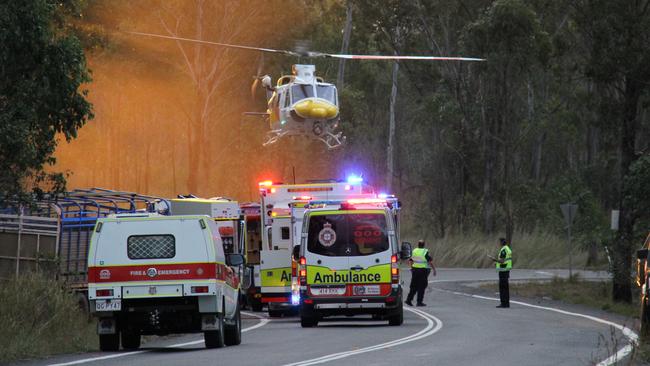 The lifeflight helicopter lands at the scene of a cattle truck crash on the Dawson Highway west of Calliope in which the driver was trapped by the legs for almost 90 minutes.