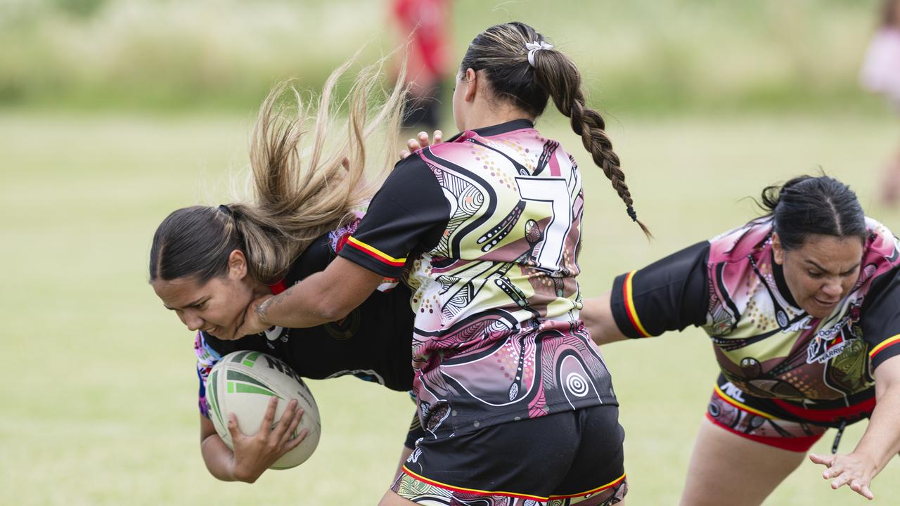 Toowoomba Warriors players Emily Young (#7) and Jessica Sampson tackle Emily Robinson of ATSiCHS – Sister Girls. Picture: Kevin Farmer