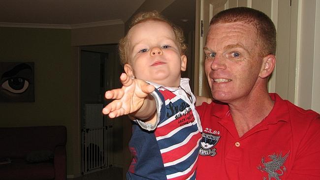 Shot Gold Coast Senior Constable Damian Leeding with his son Hudson.