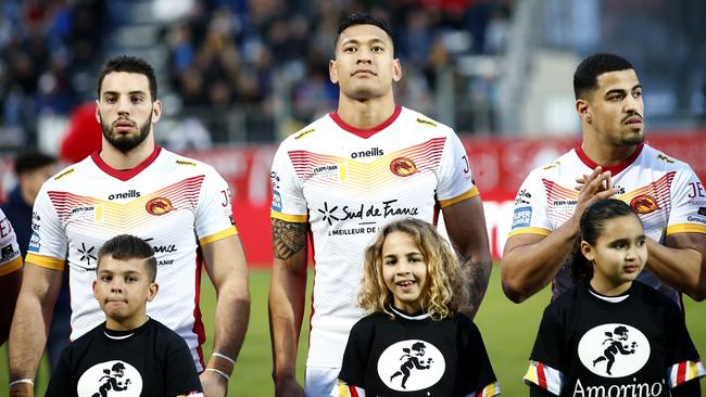 Catalans Dragons Israel Folau, centre, stands with teammates ahead of the Super League rugby match. Picture: AP Photo/Joan Monfort